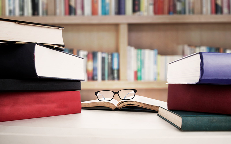 glasses resting on an open book at the library