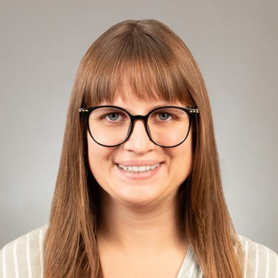 image of female with bangs and round glasses