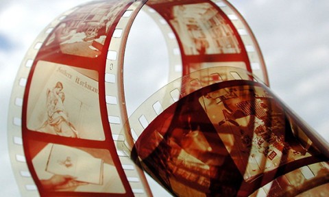 Film strip showing images including a couple embracing.