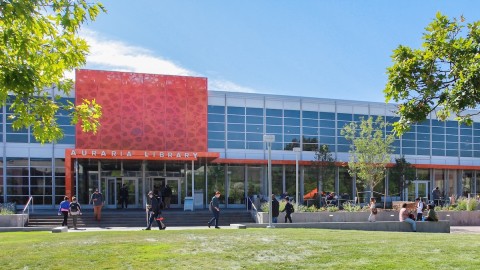 Auraria Library Launches National Search for New Director The front view of a building featuring a prominent large orange sign, showcasing its vibrant and eye-catching design.