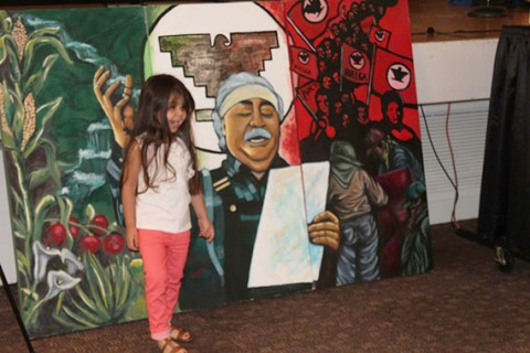 Image of Lalo Delgado mural, with smiling Chicana girl. Image of Lalo Delgado Poetry Festival